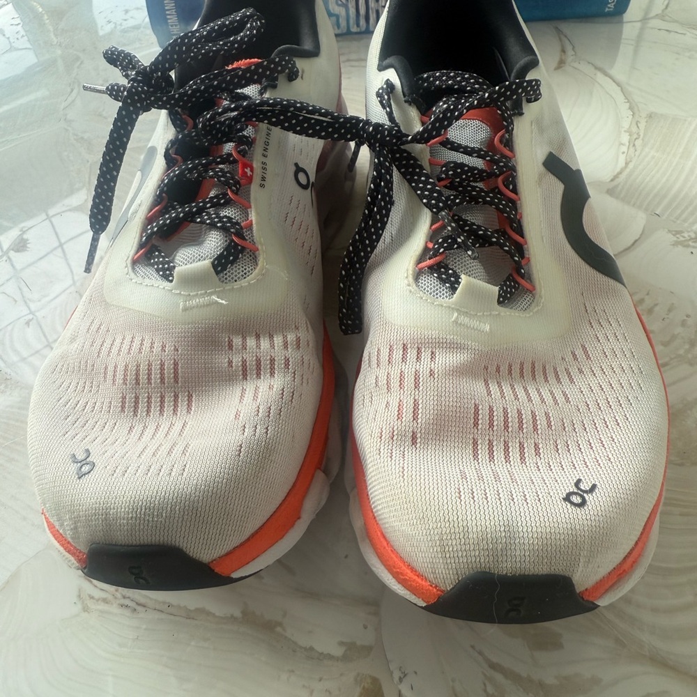 On Running Sneakers with Black and Orange Accents